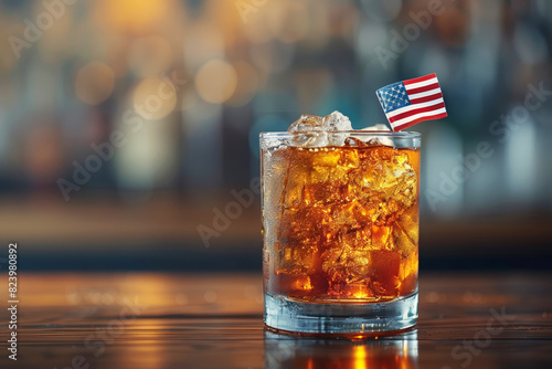 Glass of cola with ice and an American flag, perfect for patriotic celebrations or themed restaurant promotions.