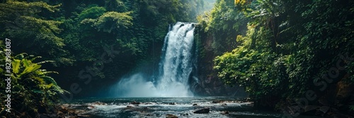 A large waterfall cascading down amid lush green forest foliage