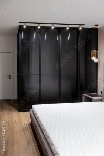 Metal partition of the dressing room in the bedroom, aluminium sliding system. The concept of modern interior and design.