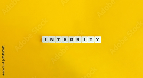 Integrity Word. Concept of Upholding strong moral principles and being consistent in actions and values. Text on Block Letter Tiles on Yellow Background. Minimalist Aesthetics. photo