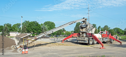 Stone Slinger Conveyer Truck delivering Construction Aggregate