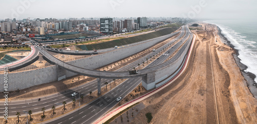 Viaduct of Avenida Escardot and descent to the Costa Verde highway in Lima. Panoramic view showing the integration of urban infrastructure with the coastal shoreline.