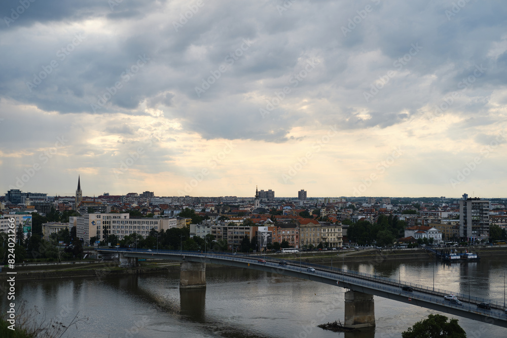 Serbia - Beautiful Panoramic view of Novi Sad and Danube River, spring cloudy evening. A bridge across the river for cars and pedestrians. View from Petrovaradin fortress.
