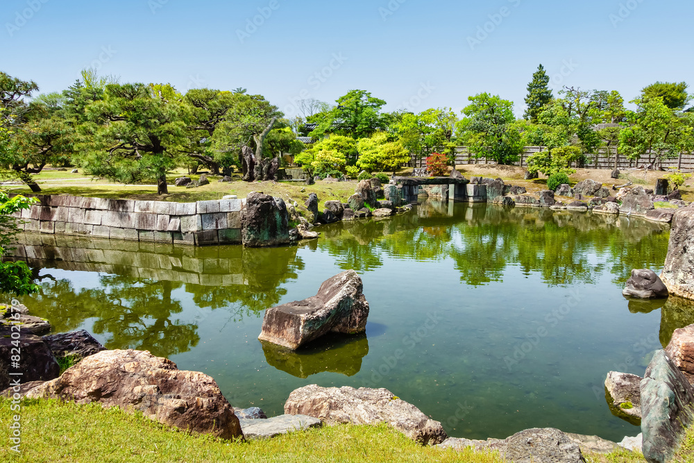 Japanese garden with water pond, rocks and green plants at Nijo Castle, Japan. Japanese garden with water pond, rocks and green plants at Nijo Castle, Japan.