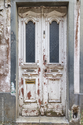 Peeling paint on an old wooden door.
