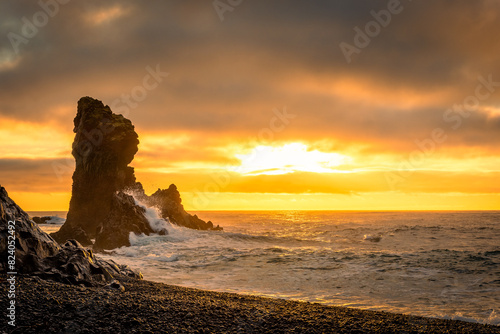 Sunset over the volcanic lava formations of Djupalonssandur beach,  Iceland photo