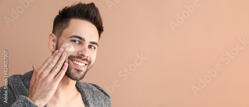 Handsome man applying clay ...