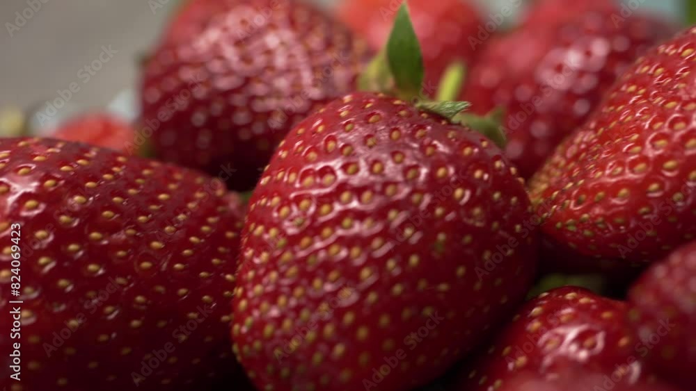 Close-up. Macro. Circular rotation of ripe, fresh strawberries. Depth of field. The texture of the berry. Green leaves Close-up. Macro. Circular rotation of ripe, fresh strawberries. Depth of field. The texture of the berry. Green leaves