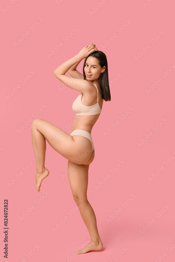 Beautiful young woman in beige underwear on pink background Beautiful young woman in beige underwear on pink background