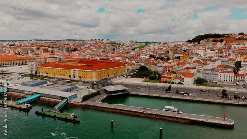 Aerial view of Lisbon downtown on a sunny day with epic cloudy sky. Flying up from Tagus River to Paco do Arco.  photo