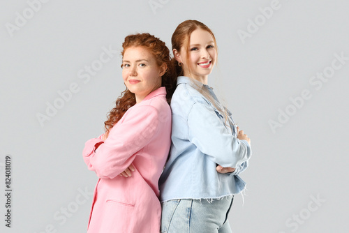 Stylish happy redhead siste...