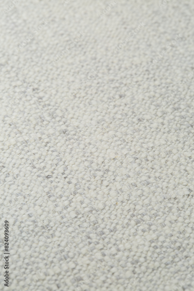 Soft white woven upholstery fabric texture. Close-up detail photograph.
