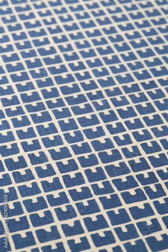 Retro blue and white geometrical pattern. Vintage woven upholstery fabric texture. Close-up detail photograph.