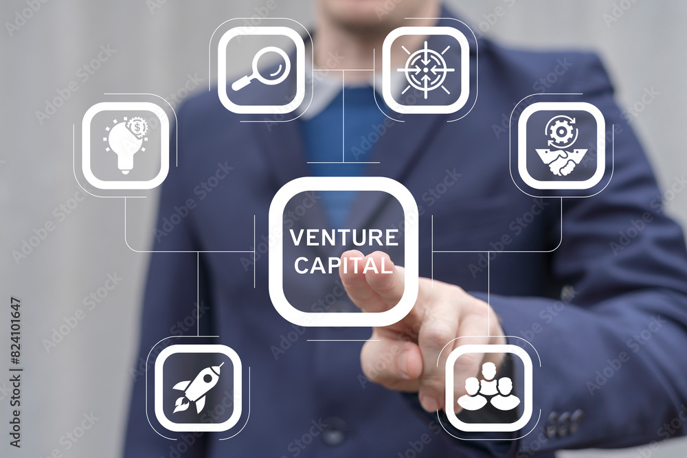 Business man using virtual screen presses text: VENTURE CAPITAL. Fundraising idea, funding new innovative project, donation, investing or venture capital (VC) to support startup idea business concept. Business man using virtual screen presses text: VENTURE CAPITAL. Fundraising idea, funding new innovative project, donation, investing or venture capital (VC) to support startup idea business concept.