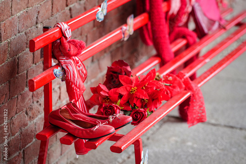 Red shoes on bench against violence against women