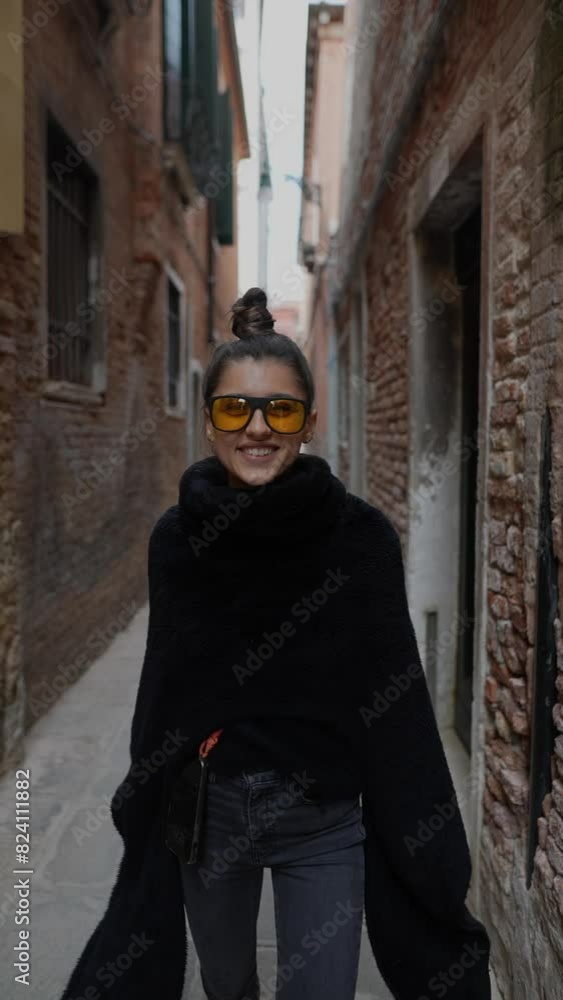 A fashionable young woman joyfully walks through the streets of ancient Venice. A fashionable young woman joyfully walks through the streets of ancient Venice.