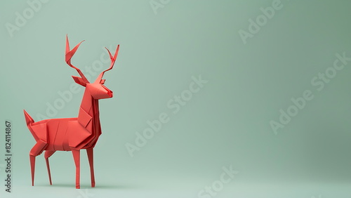 red origami deer isolated on green background