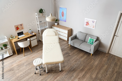 Interior of medical office with couch  sofa and doctor s workplace