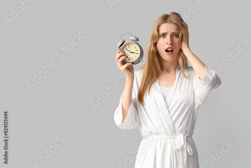 Young woman with alarm cloc...