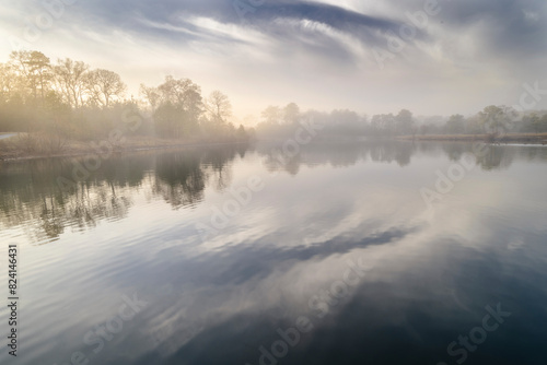USA, New Jersey, Cape May Nature Center. Foggy lake and forest landscape at sunrise. photo