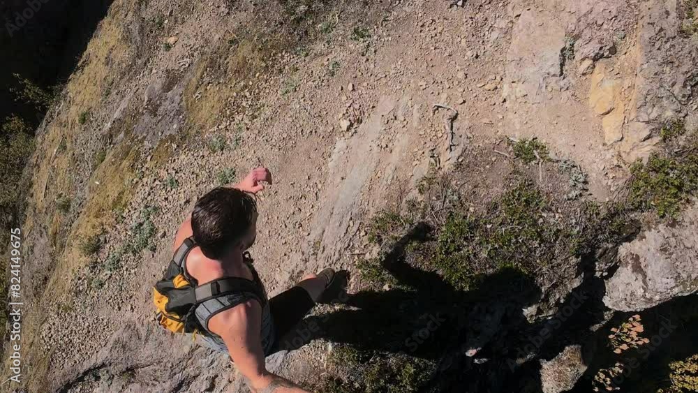 POV Top View of Man Hiking Mountain Ridge with Steep Cliffs POV Top View of Man Hiking Mountain Ridge with Steep Cliffs