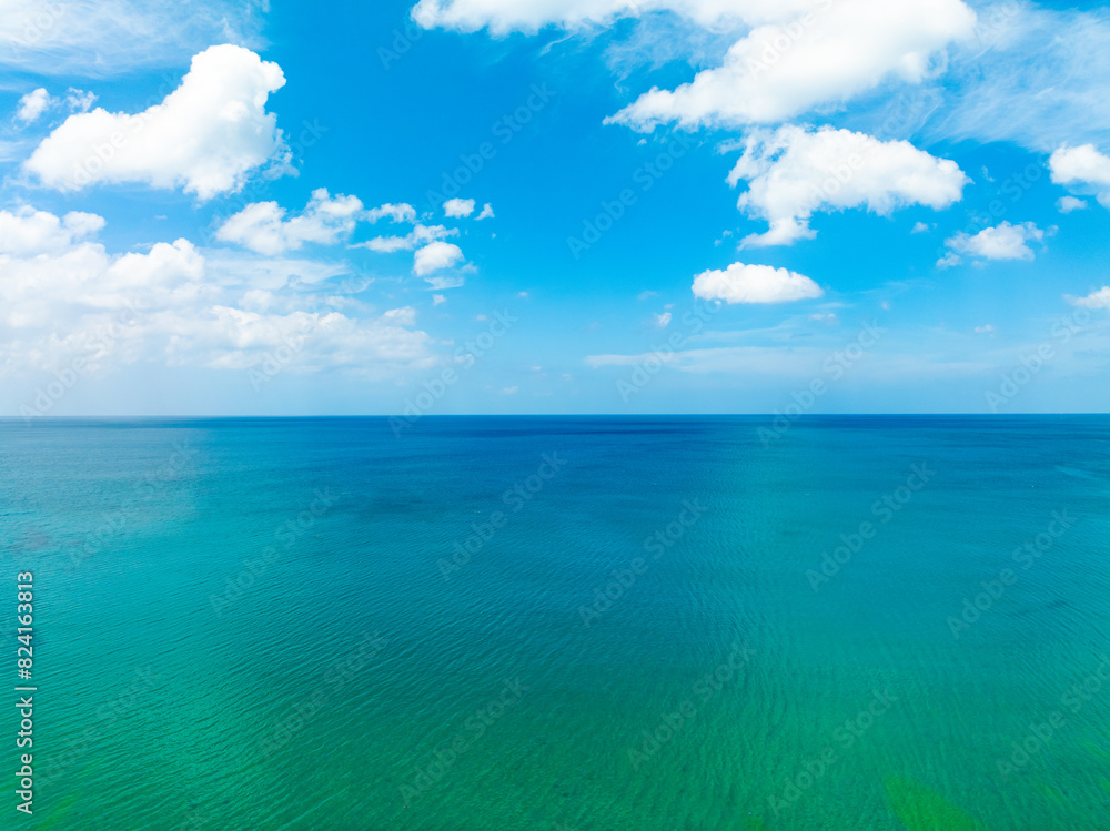 Aerial view of a blue sea surface water texture background,Sun reflections over ocean, Aerial flying drone view Waves water surface texture on sunny tropical ocean in Phuket island Thailand