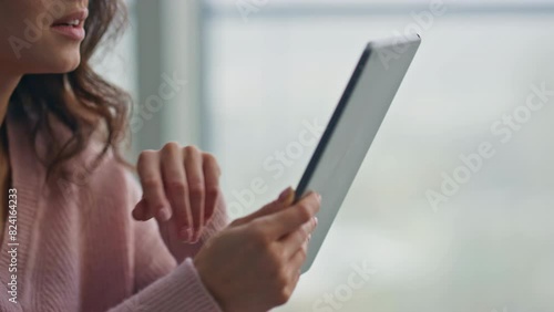 Smiling housewife swiping tablet reading at kitchen closeup. Lady holding pad photo