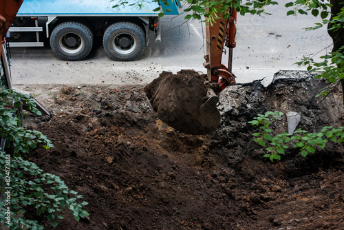 Excavator bucket digging soil outdoor