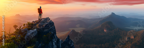 Triumphant Hiker Gazes at Sunrise from Mountain Summit, Symbolizing Ambition and Achievement photo