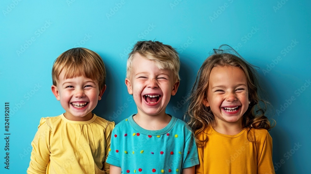 portrait of children in front of clean blue background portrait of children in front of clean blue background