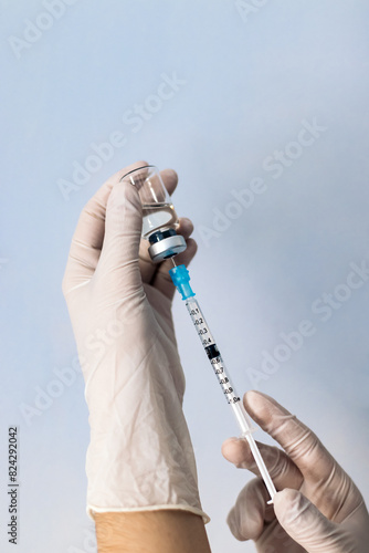 Hand holding syringe with vaccine. Vaccination concept. Covid-19