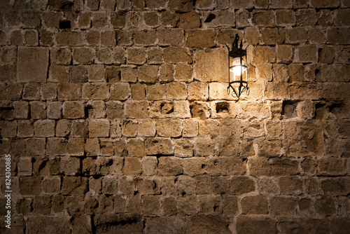Dark brick wall background with an old lantern
