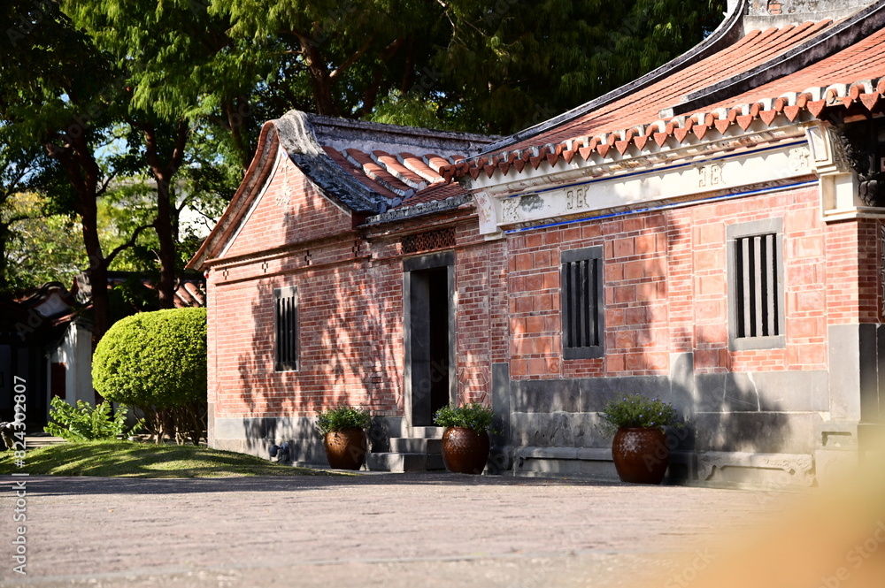 Fototapeta premium Taipei, Taiwan - Jan 19, 2024: Lin An Tai Historical House and Museum (林安泰古厝) showcases a harmonious blend of lush greenery and tranquil pavilions, embodying the essence of Feng Shui principles.