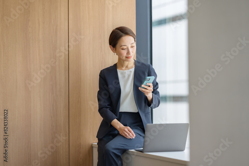 スマートフォンを使うビジネス女性 photo