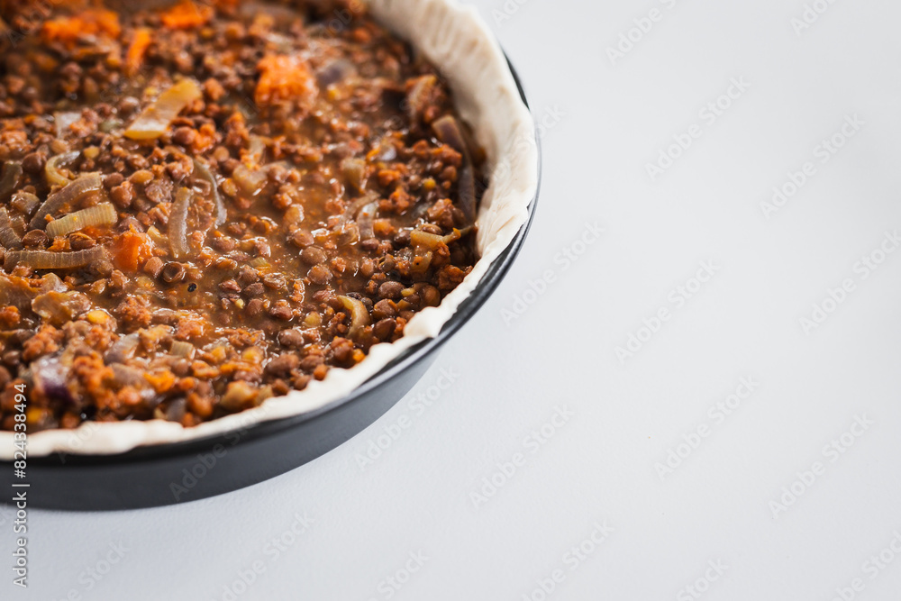 plant-based lentil and pumpkin pie with filling just poured into the pastry before cooking it plant-based lentil and pumpkin pie with filling just poured into the pastry before cooking it