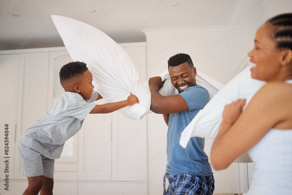 Obraz premium Dad, mom and child in pillow fight in bedroom with morning games, bonding or playful happy family in home. Mother, father and son playing together on bed with love, fun and smile with energy in house
