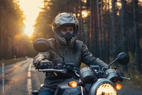 Motorcyclist in helmet and jacket sitting with motorcycle