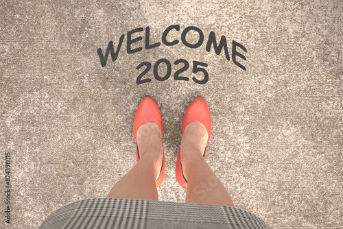 Welcome 2025. New year. Words in front of a woman wearing heels. Top view.