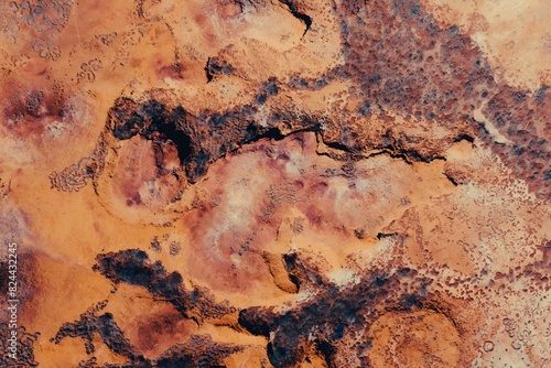 Abstract Aerial View of Desert Terrain With Red Rocks and Dirt Textures Patterns Kimberley Broome Pilbara Region Western Australia  photo