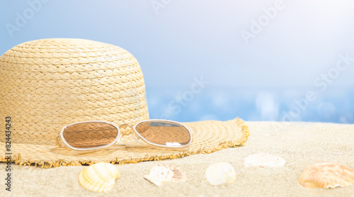 Summer Beachscape: Sand and Sea Background. Straw hat on the sand. Copy space 