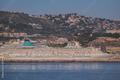 Classic and modern cruise ship cruiseship liners maintenance repair modernization refurbishment overhaul dry docked by French shipyard in Marseille, France with dock and cranes	 photo