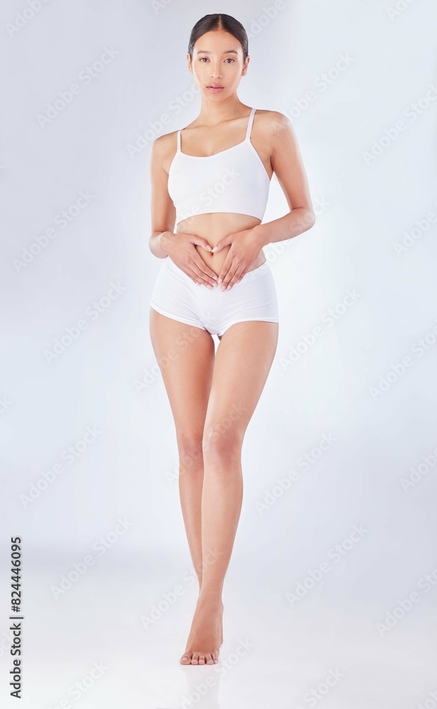 Obraz premium Body, health and portrait of woman in underwear on studio white background for digestion or gut health. Beauty, fitness or skincare and natural model confident with dermatology, diet or nutrition