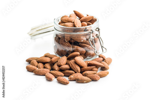 Peeled almond nuts in jar isolated on white background.