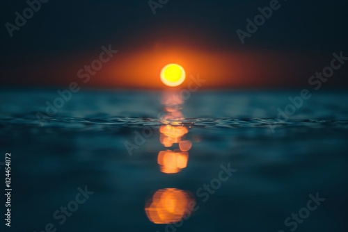 Out of focus sun setting over the ocean glowing orange with dark blue background - generative ai