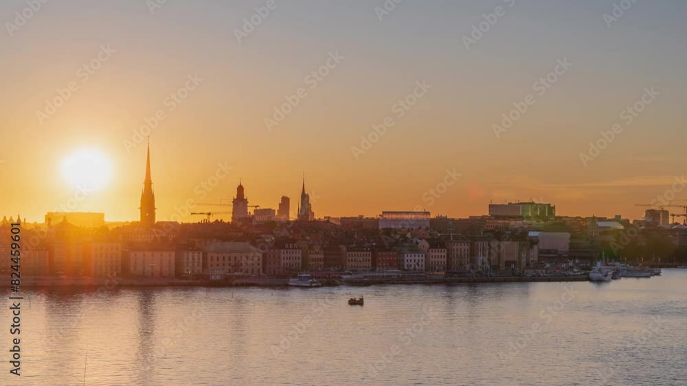 Time lapse of a sunset over the city skyline of Stockholm, over the old town, with the waterfront, boats, church spires and historical buildings. Time lapse of a sunset over the city skyline of Stockholm, over the old town, with the waterfront, boats, church spires and historical buildings.