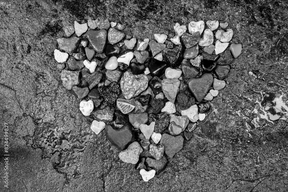 Rock heart composed of dozens of small stone hearts. Lava, limestone, sandstone, granite, coral or basalt with different surface structures from sites around the world. Symbol of love. Black and white Rock heart composed of dozens of small stone hearts. Lava, limestone, sandstone, granite, coral or basalt with different surface structures from sites around the world. Symbol of love. Black and white