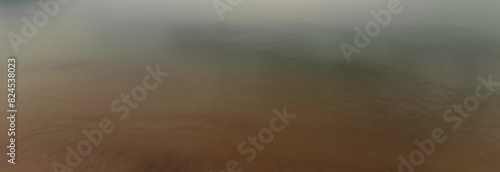 The surface of the river has a gradient color from green to brown.

