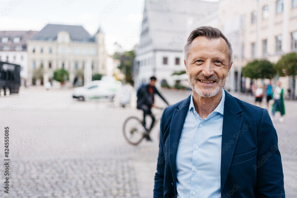 A confident middle-aged man with a beard smiling while standing in an urban city environment, exuding happiness and professionalism. A confident middle-aged man with a beard smiling while standing in an urban city environment, exuding happiness and professionalism.