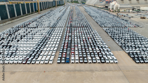 hight angle view from drone, many new cars parked at commercial port to wait for international shipping.