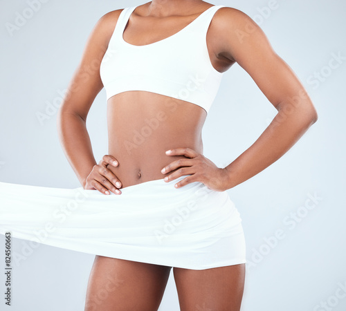 Body, underwear and fabric in studio for diet, fashion and healthy weight loss on white background. Woman, skin and model in silk cloth for natural beauty, wellness and slim stomach for balance